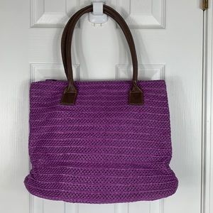 Avon purple woven purse with brown handles. 1 Zippered pocket inside, 3 smaller